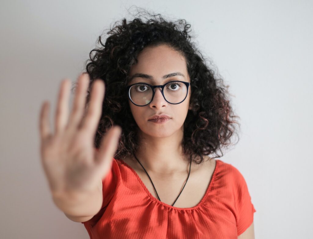 Woman holding up her hand saying no.